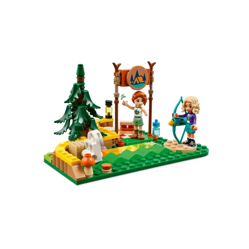 Two toy figures in a camping scene with a tree, campfire, and sign invite kids into an adventurous world. One figure holds a cup, the other a fishing rod. This LEGO building set features colorful bricks forming ground and scenery elements, perfect for imaginative pretend-play.