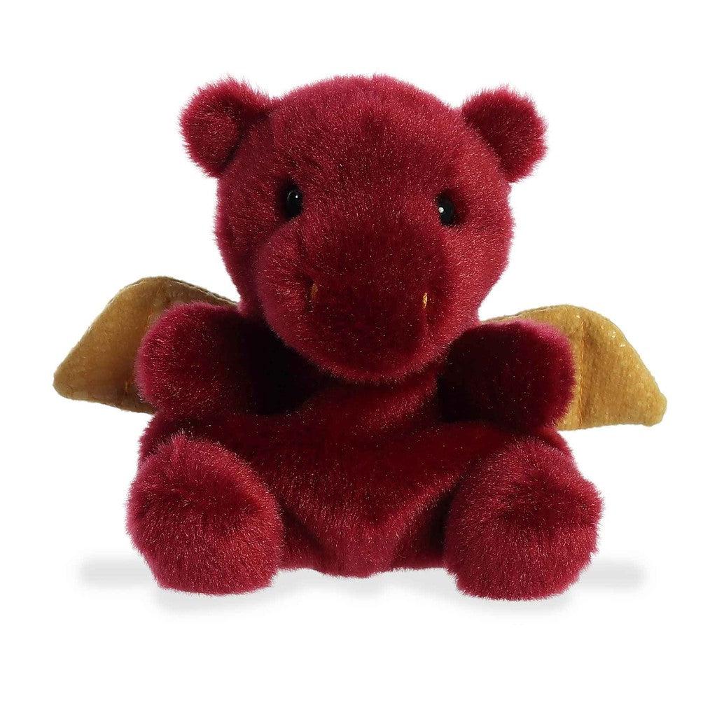 A plush red dragon toy with small golden wings, part of the Palm Pals collection, sits against a white background.