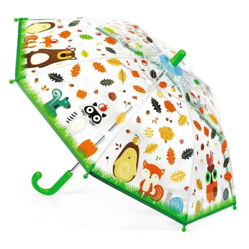 Children's umbrella with safety system, featuring a transparent design with green trim and adorned with colorful cartoon animals, leaves, and acorns—perfect for a delightful forest walk.