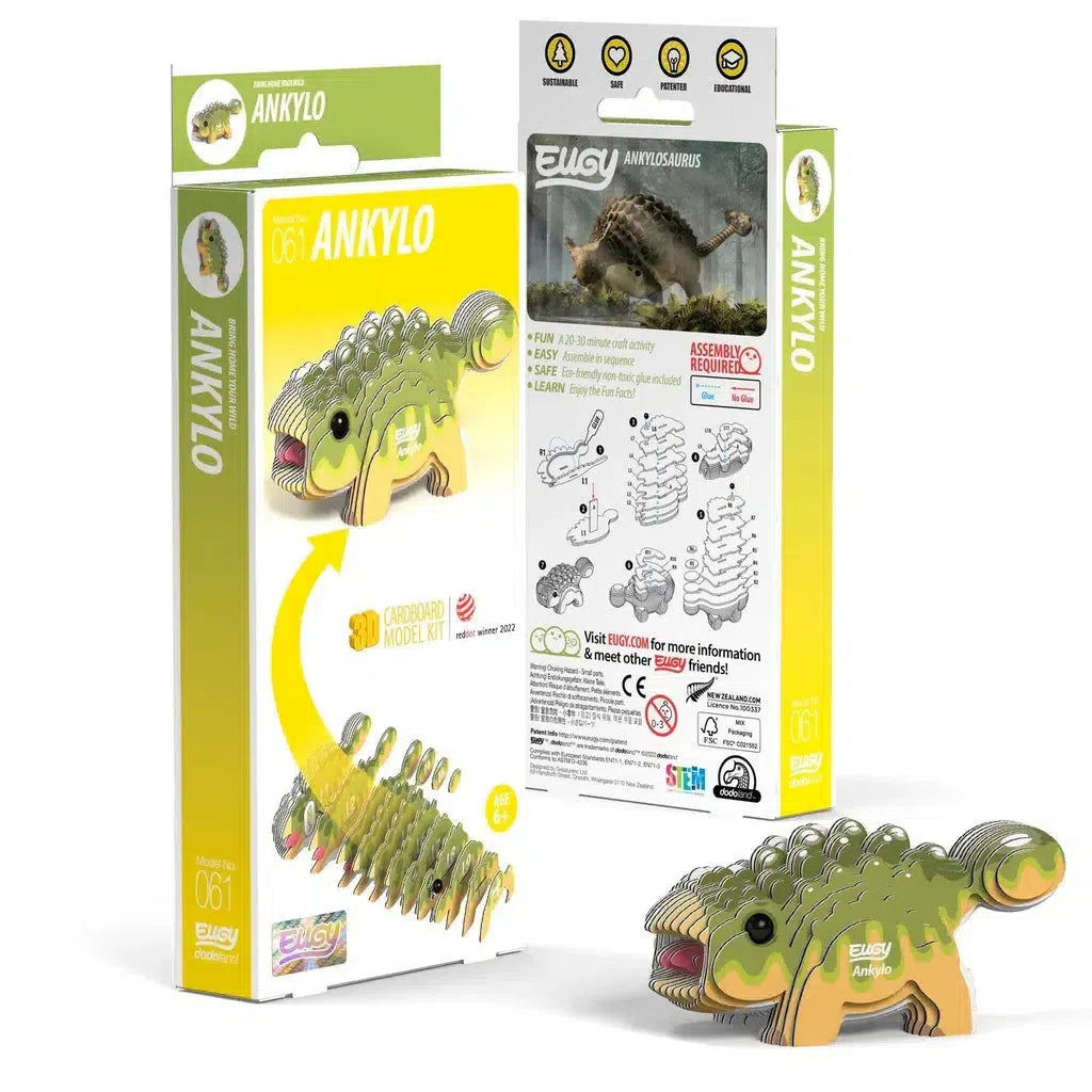 Cardboard model kit of the Ankylosaurus dinosaur named Anklyo with packaging. This eco-friendly 3D puzzle shows the assembled model, assembly diagram, and safety icons. For ages 6+, made entirely of cardboard.