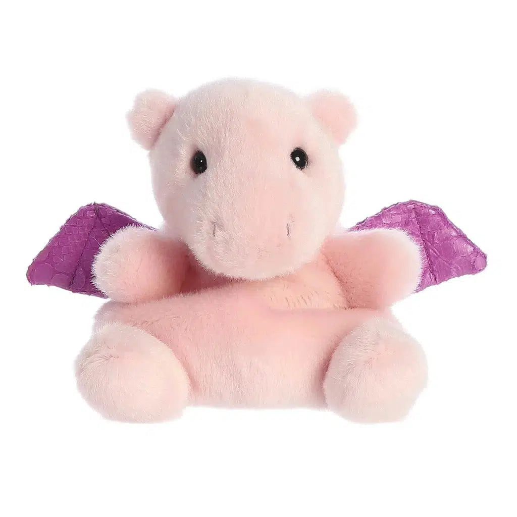 This adorable Palm Pals plush pink dragon features charming purple wings and enchanting black eyes, sitting upright and ready for hugs.