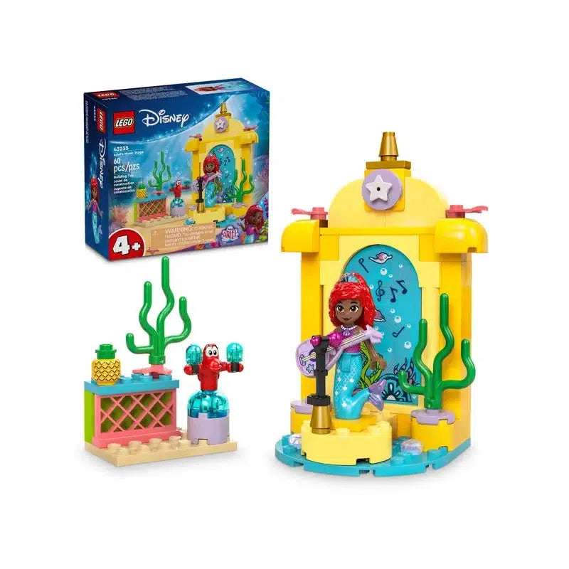 This LEGO Disney building toy features a charming mermaid figure, a vibrant yellow castle-like structure, lush green sea plants, and an adorable sea creature. In the background, the box art displays all the whimsical set details.