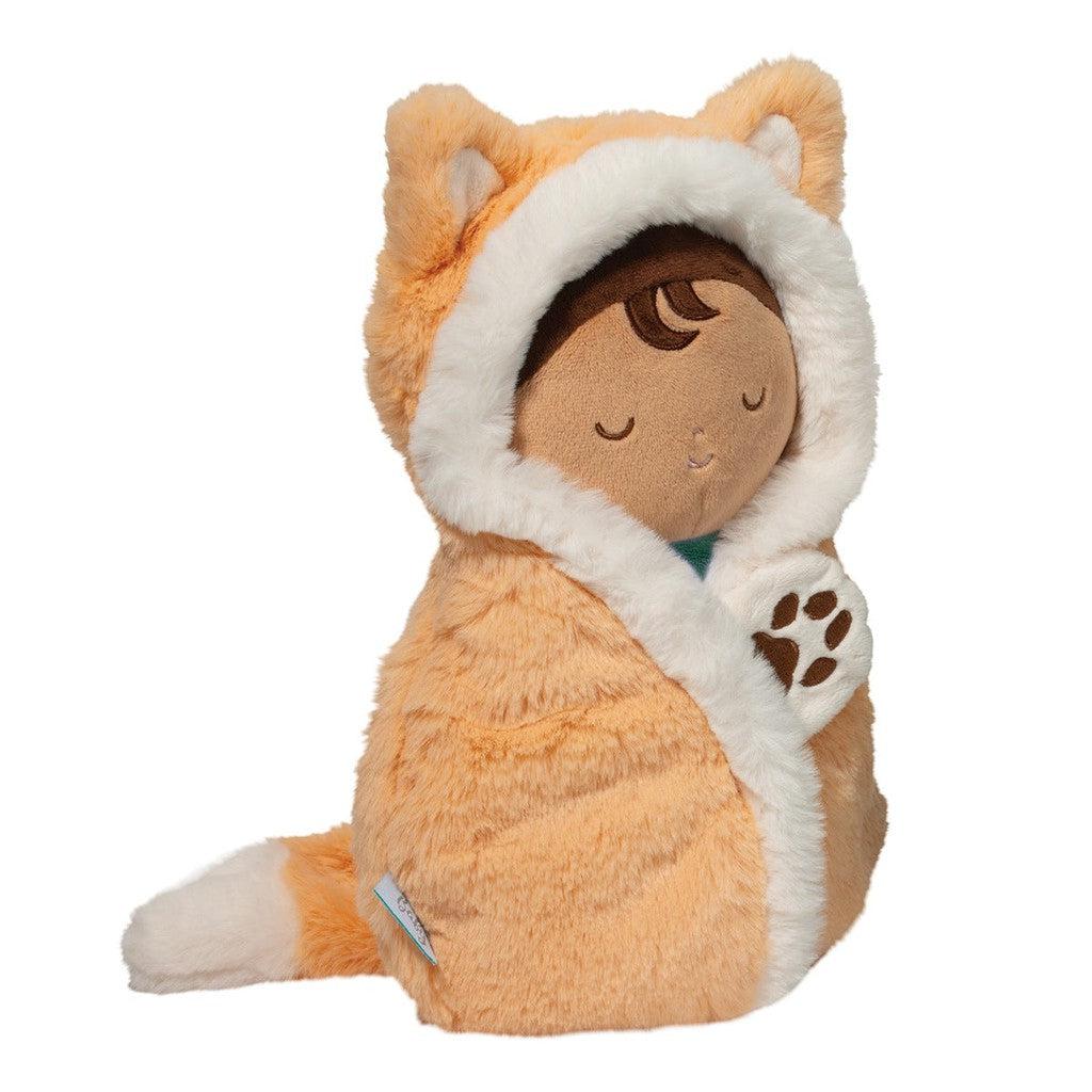 A soft doll snuggled in an orange fox costume, complete with a fluffy hood and tail, captures the essence of a Baby Fox Hug. Its eyes are closed in serenity, paw gently held as if dreaming of a woodland adventure.