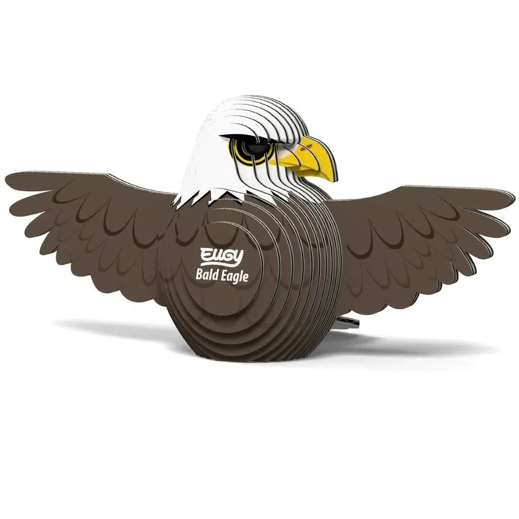 A captivating cardboard 3D puzzle, this model showcases a bald eagle with outstretched wings and a vivid yellow beak. Proudly labeled "Bald Eagle" and "Eugy" on its chest, it brings nature's elegance into your space.