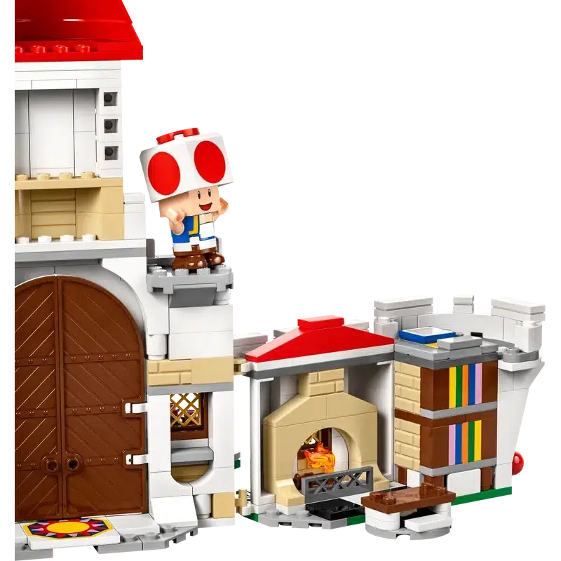 This Lego playset showcases a charming red-roofed house with large brown doors, featuring a character in a red hat and vest, and a cozy fireplace beside a bookshelf. Perfect for kids who love imaginative adventures.