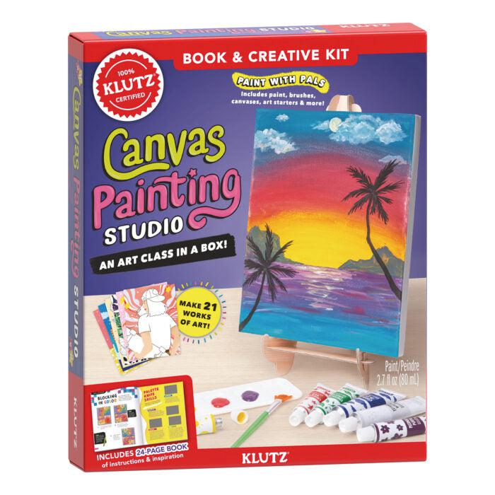 Klutz Canvas Painting Studio. Shows a small art easel with palm tree and ocean painted on it, surrounded by art supplies