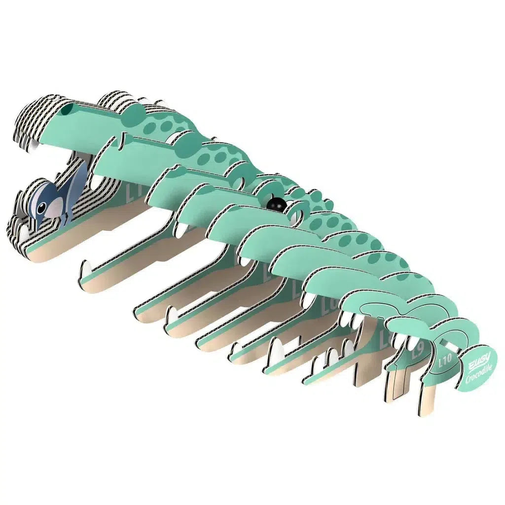 Illustration of an eco-friendly 3D puzzle resembling a teal and white cartoon crocodile, composed of interlocking pieces arranged in a lined formation.