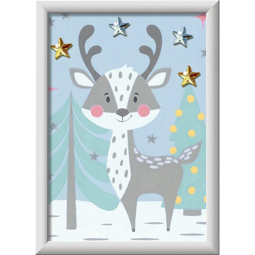 A cartoon reindeer with antlers stands in a snowy scene, surrounded by decorated trees and four metallic stars. This charming spectacle comes to life with the Ravensburger CreArt Kids Painting Kit, offering the perfect paint by numbers experience for young artists.