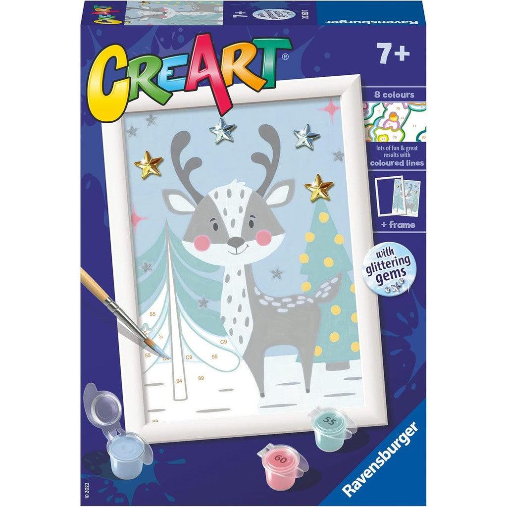 Discover the Ravensburger CreArt painting kit box featuring a charming reindeer illustration. This Paint by Numbers Kit includes paint pots, a brush, and glittering gems, making it perfect for budding artists ages 7+.