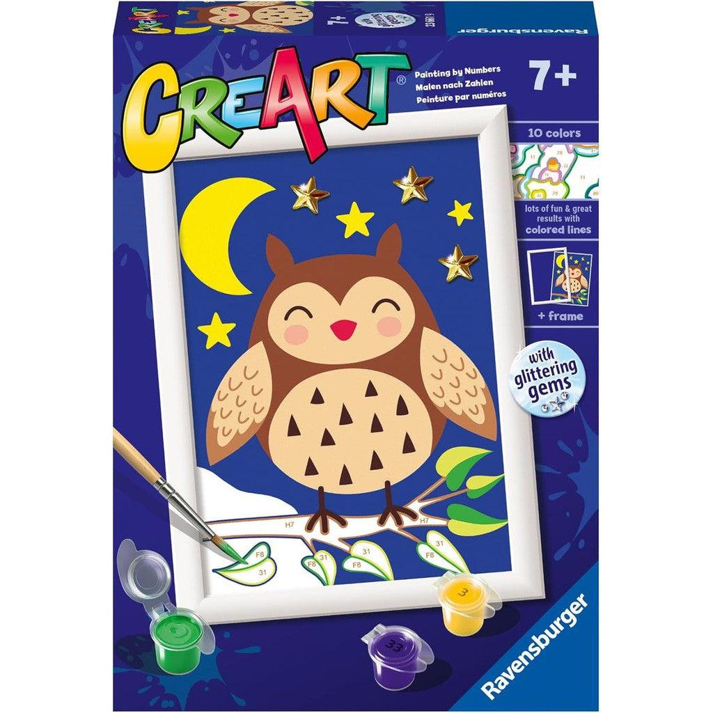 Box of a "Ravensburger CreArt" Paint by Numbers kit for ages 7+, showcasing an owl, moon, and stars adorned with glittering gems. This peaceful set includes a frame and 10 vibrant colors for painting with guided colored lines.