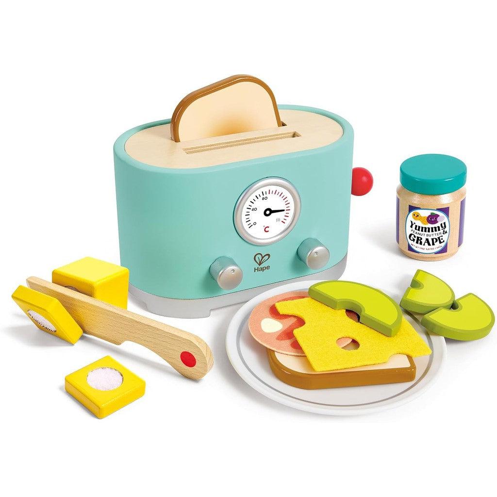 This modern look toy toaster set features a stylish wooden toaster, toast slices, cheese, avocado, knife, butter with tray, and a jam jar labeled "Yummy Grape." Perfect for little ones to enjoy pretend play with vibrant colors.