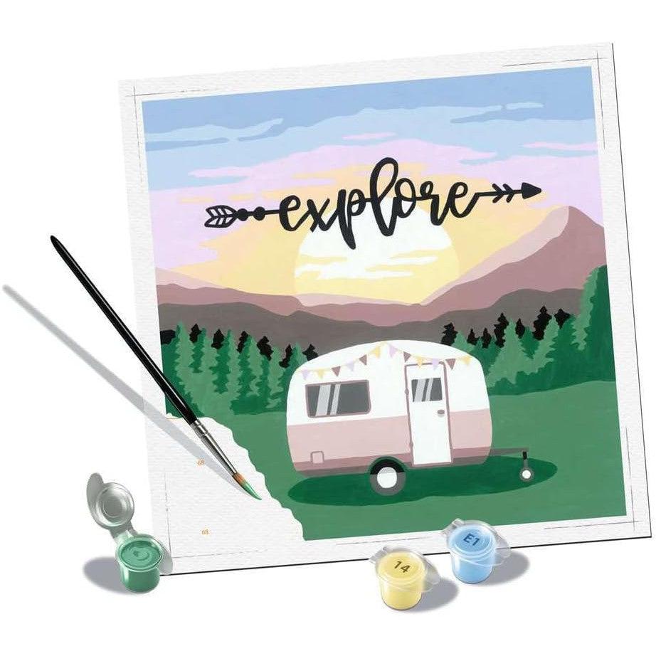 Ravensburger's Paint by Numbers kit, titled "Explore," features a captivating camper, mountain, and sunset scene. The set includes tiny paint pots and a paintbrush, perfect for arts and crafts enthusiasts.