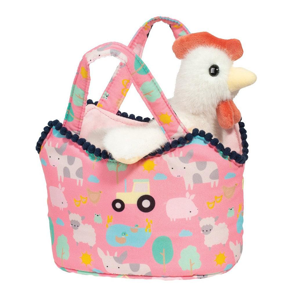 A plush Hen toy sits in a pink fabric basket adorned with animal and farm-themed patterns, part of the delightful Farm Friends collection.