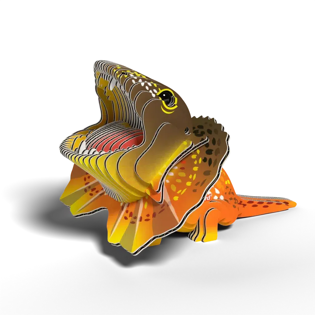 Colorful, layered paper sculpture resembling a frilled-neck lizard with an open mouth, crafted as an eco-friendly EUGY 3D puzzle. It features vibrant orange, yellow, and brown patterns.