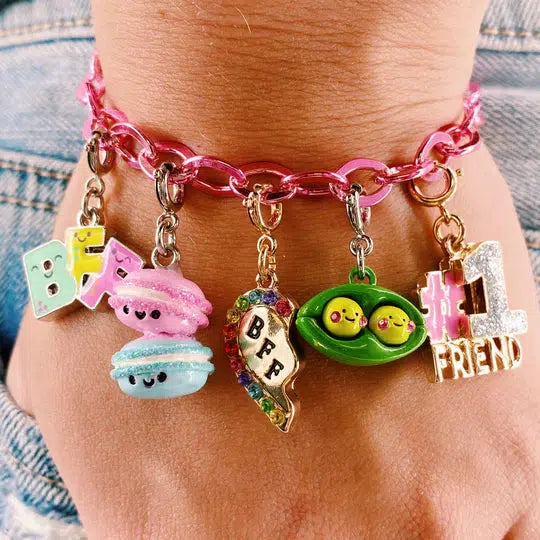 wrist wearing a bracelet with friendship-themed charms