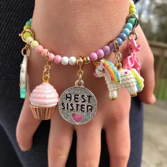 Wrist wearing a charm bracelet