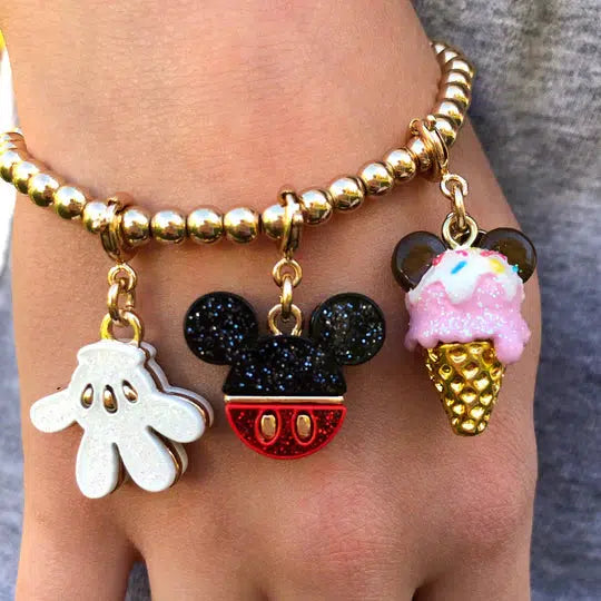 wrist wearing mickey-themed charm bracelet