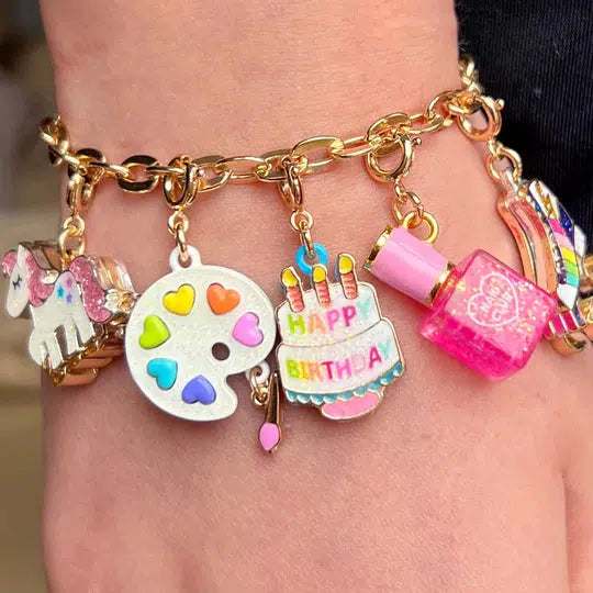 wrist wearing a brightly colored charm bracelet