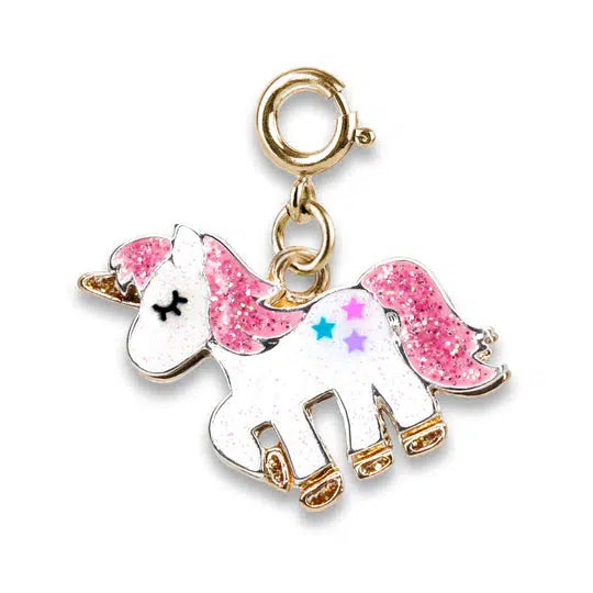 a charm shaped like a white and pink unicorn