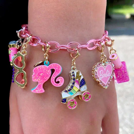 wrist wearing pink charm bracelet