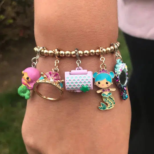 wrist wearing mermaid-themed charm bracelet