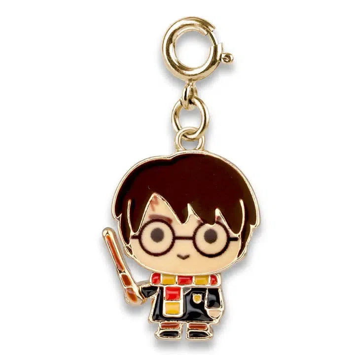 A cartoon-style keychain charm of a character resembling Harry Potter, with glasses, holding a wand, and wearing a black robe and a red-and-yellow scarf.