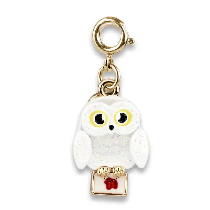 A glittery white owl charm reminiscent of the wizarding world, with big eyes holding a white envelope with a red seal, attached to a gold clasp. Perfect for any Harry Potter fan, this Hedwig charm captures the magic in every detail.