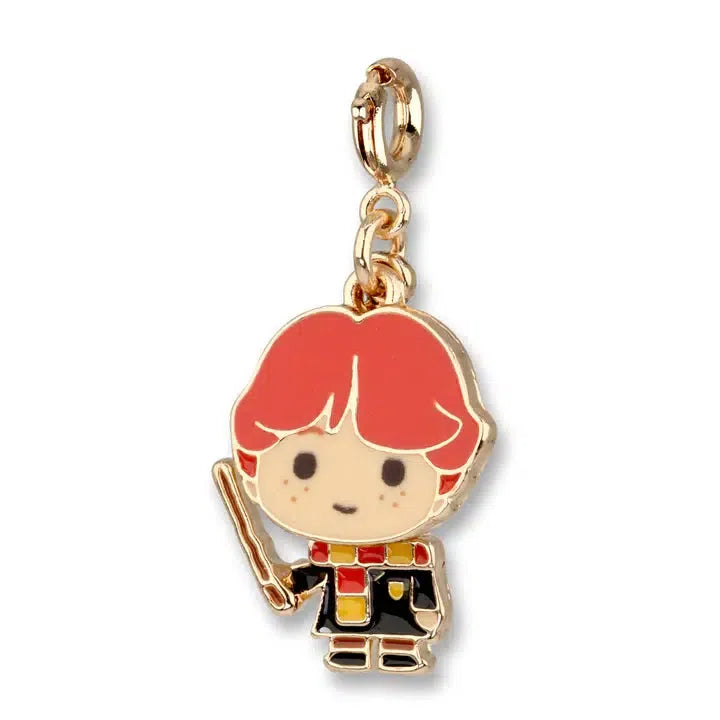 A chibi-style charm featuring Ron Weasley with his signature red hair, holding a wand and wearing a black robe adorned with a Gryffindor scarf in red and yellow.