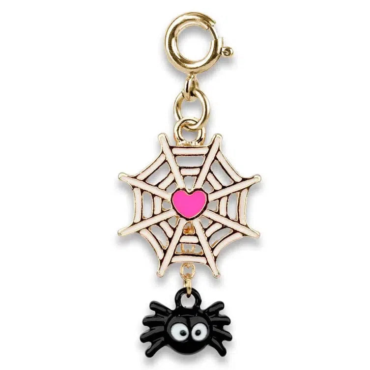 Discover a spider charm in a delightful web of style, featuring a pink heart and crafted from acrylic &amp; base metal. A small black spider with big eyes playfully hangs below, attached by a gold clasp.