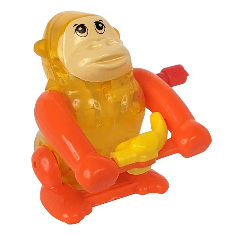 This classic-style toy monkey features orange limbs and a yellow body, gripping handlebars. It's reminiscent of the Z WindUps Backflipping Gorilla, capturing the nostalgic charm of wind-up toys.