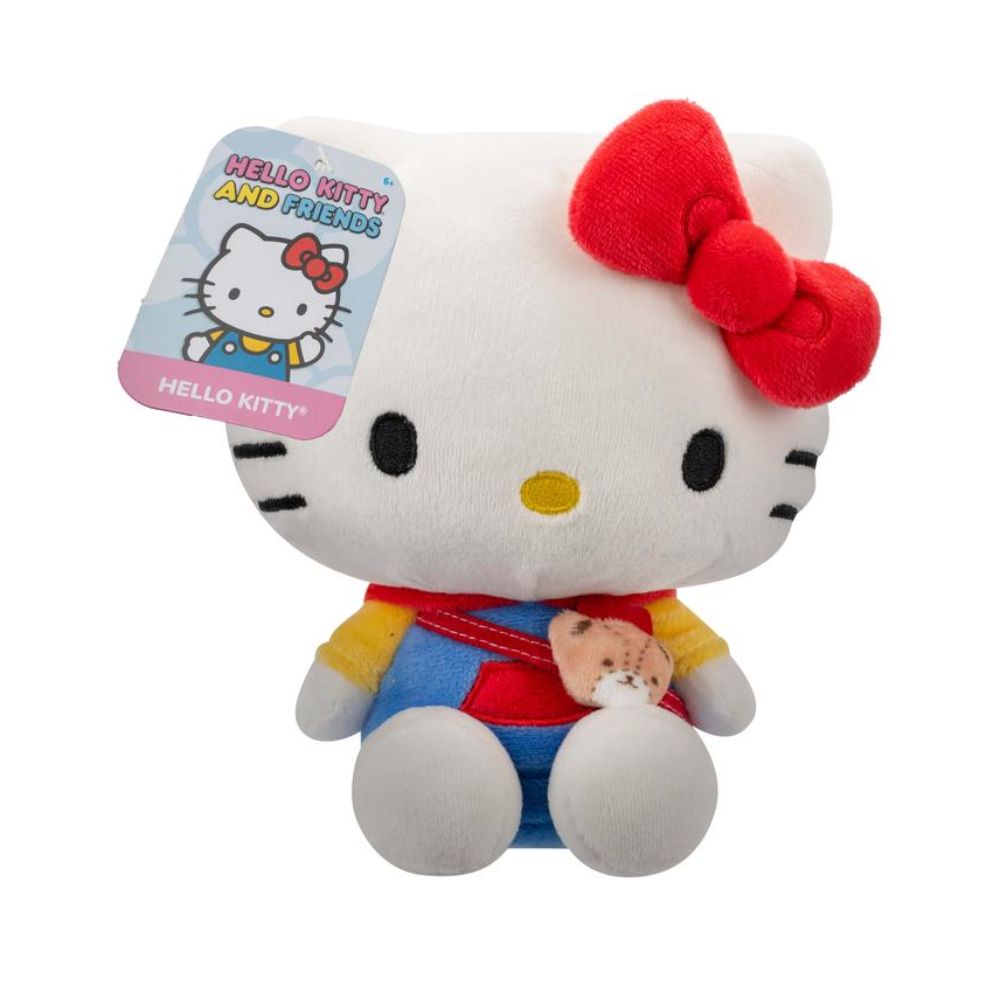 Hello Kitty plush is sitting, wearing a yellow, red, and blue outfit and wearing a satchel