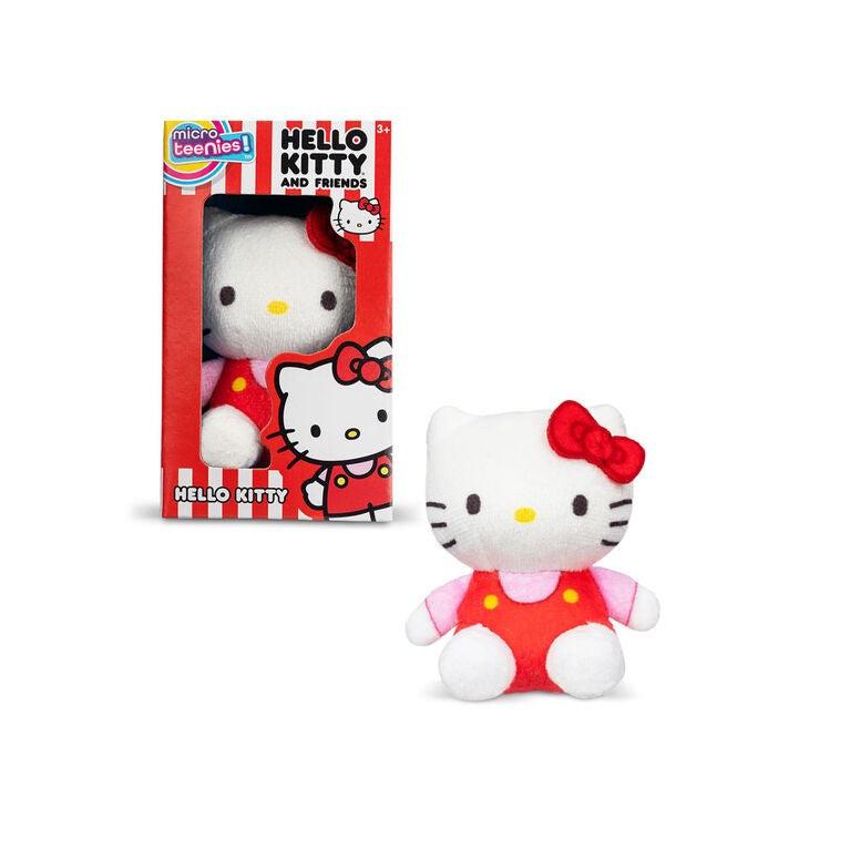 Hello Kitty plush toy with a red dress and bow, shown outside its branded packaging.