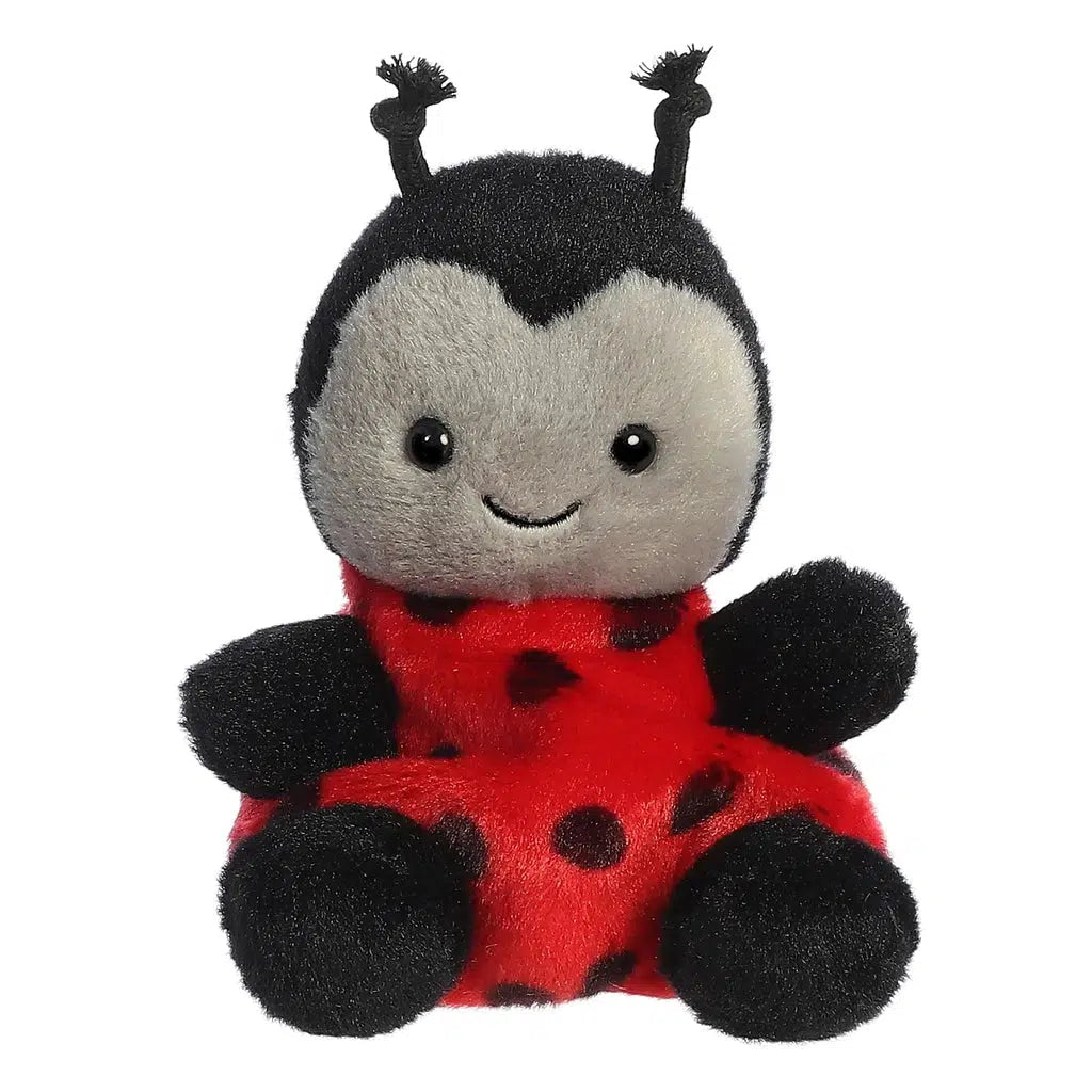 This adorable plush toy, part of the Palm Pals Collection, is a charming ladybug with a red body adorned with black spots, cute black limbs, and a delightful smiling face.