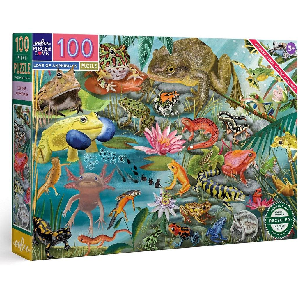 The eeBoo Kids Jigsaw Puzzle is a colorful 100-piece set featuring amphibians like frogs and salamanders. A hand holds a puzzle piece as text highlights the love of amphibian traits and their habitats.