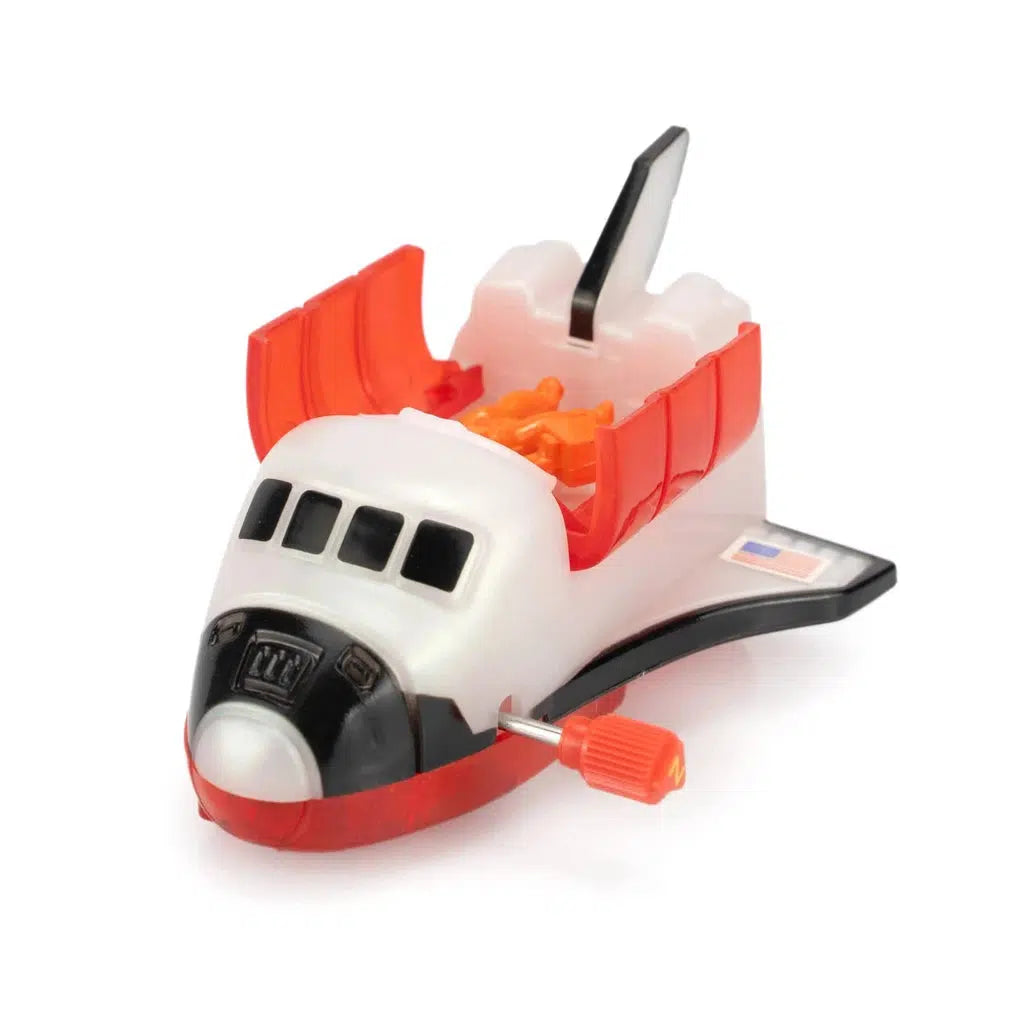 Experience a thrilling space adventure with this wind-up space shuttle toy, featuring bold red wings, a sleek black nose, and a prominent winding key on the side.