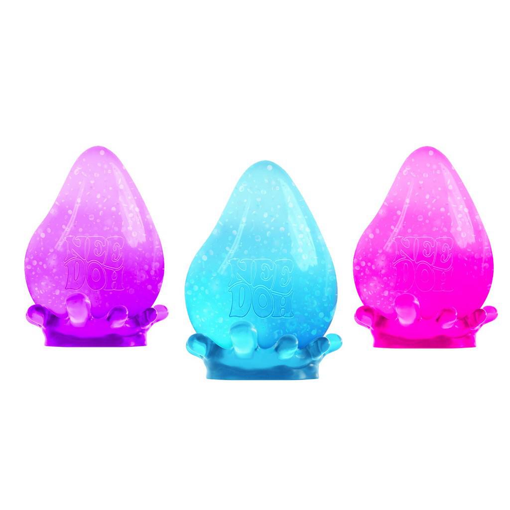 Three soft, colorful NeeDoh toys in purple, blue, and pink arranged in a row. Each has a teardrop shape with a wavy base, creating a sensory oasis for relaxation.