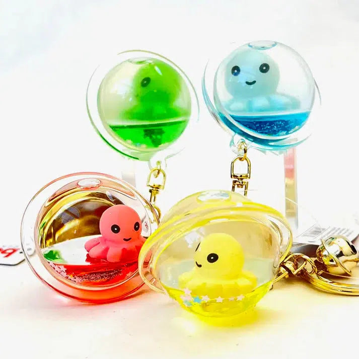 Four transparent key charms feature colorful rubber octopuses—green, blue, pink, and yellow. These silly animals float inside each charm filled with liquid and small decorative elements.