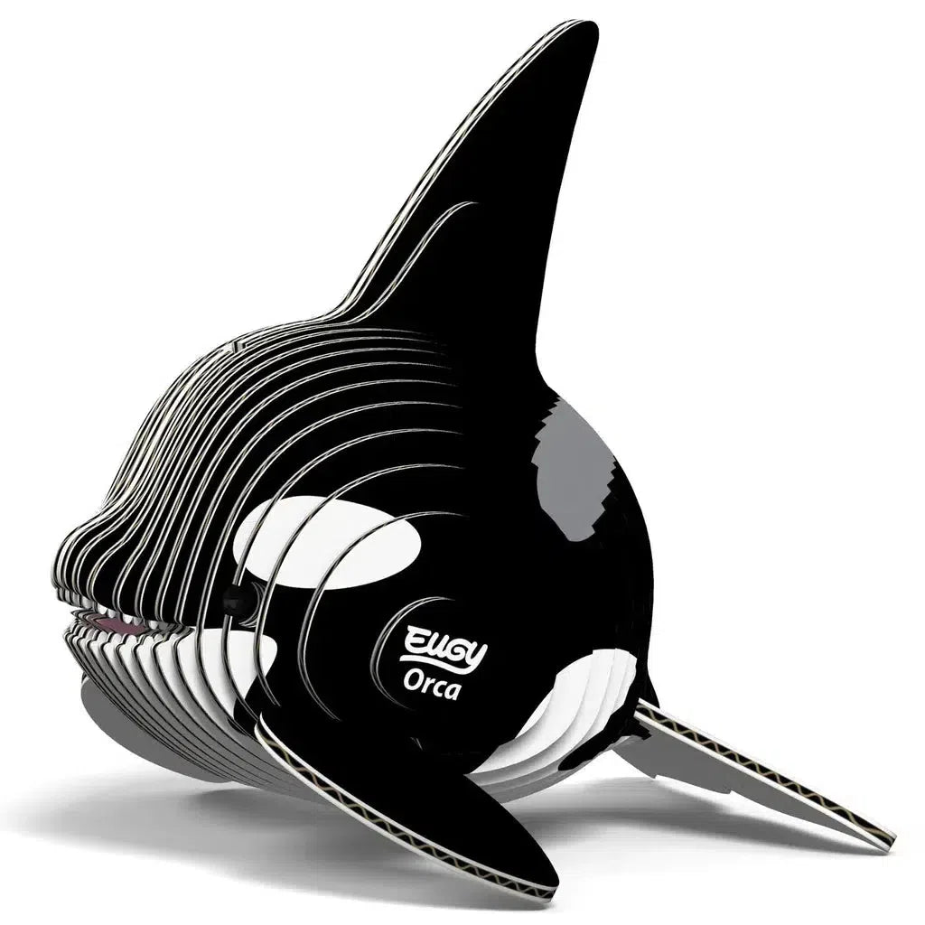 Explore the eco-friendly 3D puzzle of an orca, crafted from stacked black and white layers, with "EUGY Orca" elegantly displayed on the side.