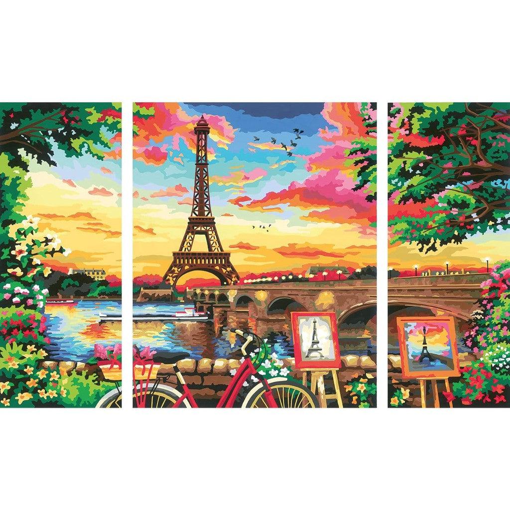 A Ravensburger CreArt masterpiece: a colorful painting of the Eiffel Tower at sunset, featuring a red bicycle, paintings on easels, and vibrant flowers along the Seine River.