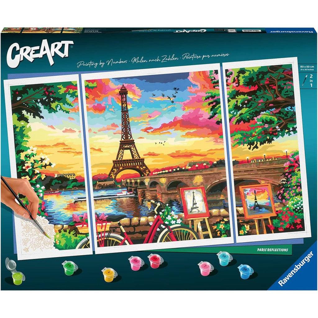 Discover the Ravensburger CreArt Paint-by-numbers kit showcasing a vibrant Eiffel Tower scene beneath a sunset sky. This Paris Reflections set includes high-quality paints and a brush, perfect for adding artistic flair to your space.