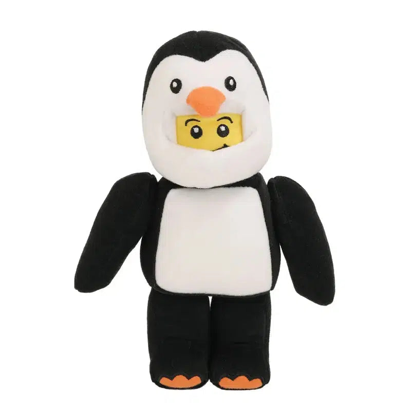 A Penguin Boy costume with an exposed yellow block figure face peeking through the opening. The joyful ensemble is black and white, complete with orange feet and beak, reminiscent of a cheerful stuffed toy come to life.