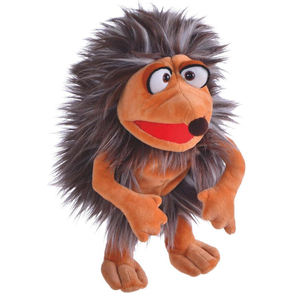 Pik the puppet resembles a brown goofy-looking hedgehog