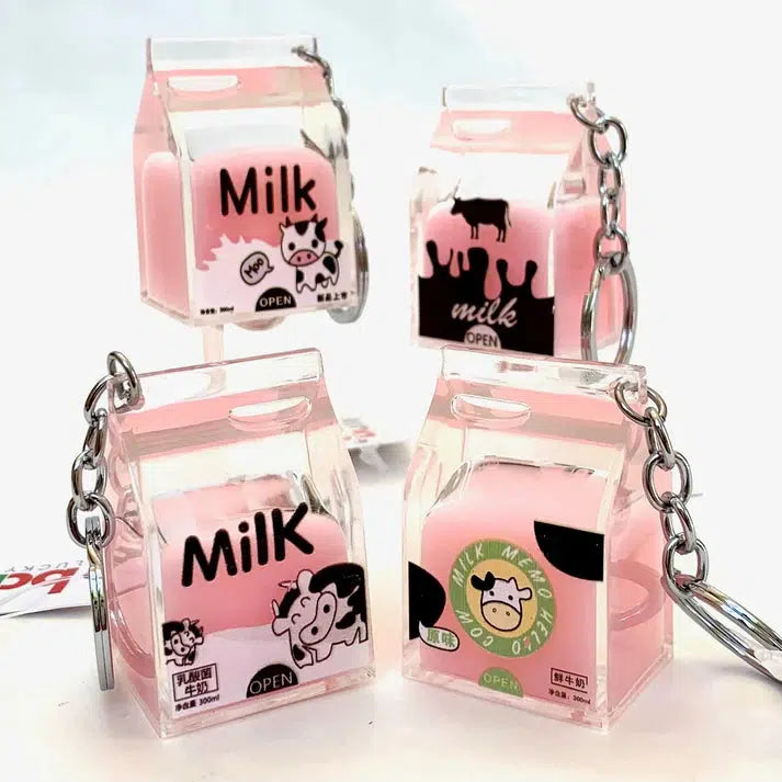 Four pink milk carton keychains with silly animal illustrations and text designs, each a delightful pink milk charm.