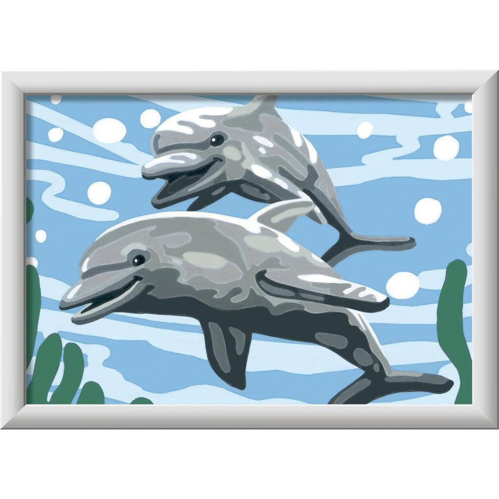 Illustration of two smiling dolphins swimming in blue water with bubbles and seaweed, reminiscent of a Paint by Numbers Kit.