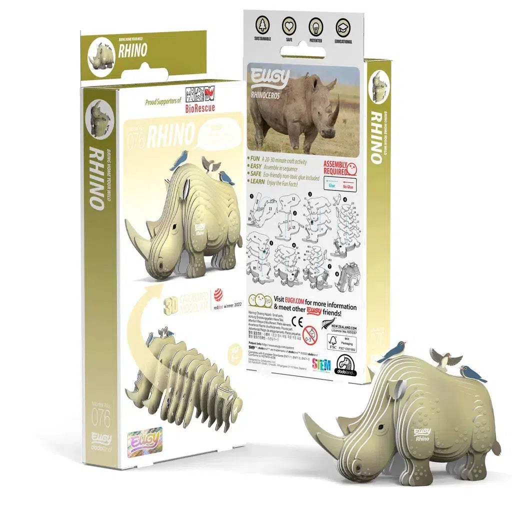 The EUGY 3D puzzle of a rhinoceros, displayed with its eco-friendly packaging, showcases the disassembled pieces. The packaging highlights its contribution to rhino conservation efforts.