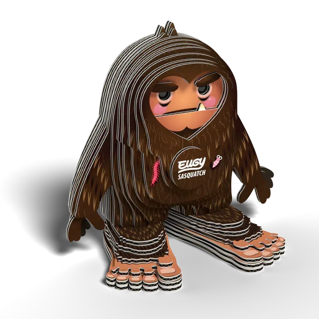 Illustration of a cartoon Sasquatch with layered lines, pink cheeks, and the word "Sasquatch" on its chest. Resembling a collectable toy, it stands on two large feet against a black background, offering an eco-friendly charm to any collection.