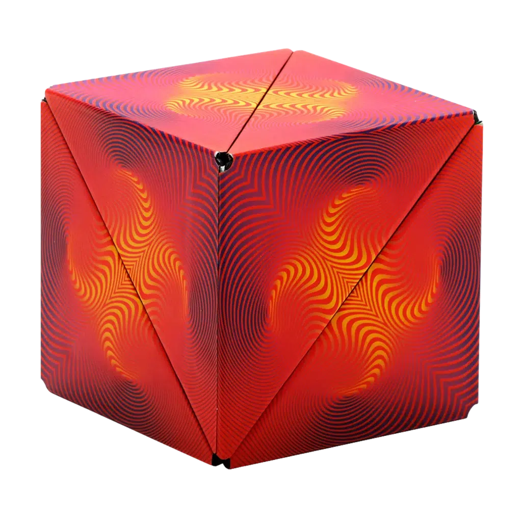 A Shashibo cube, adorned with vibrant red, yellow, and purple swirling patterns on its surface, transforms with ease to reveal hidden shapes.