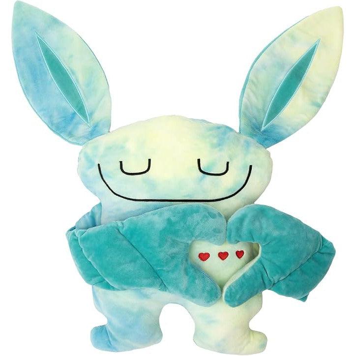 Introducing the Bumpas, a plush toy with large blue ears and a smiling face. This weighted plush toy holds a heart adorned with small red hearts and is a tye dye blue