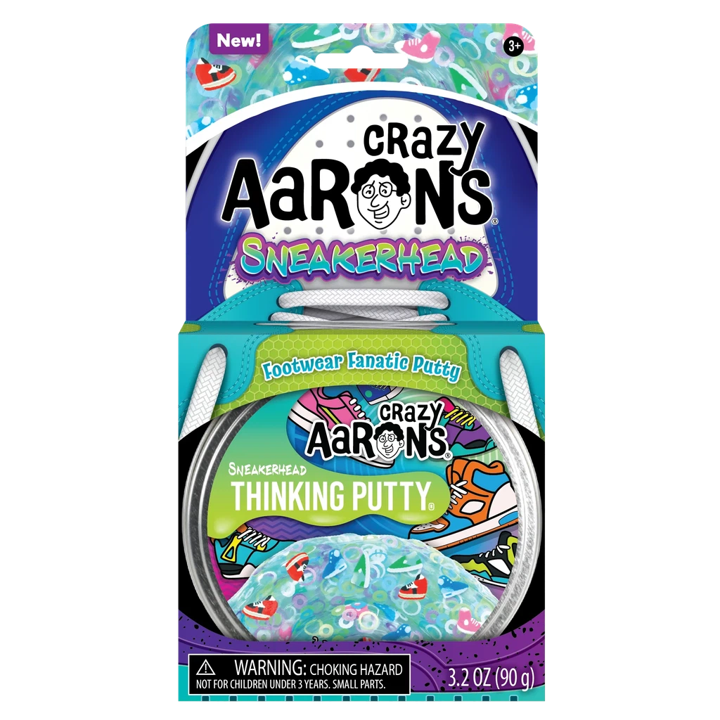 Packaging of Crazy Aaron's Sneakerhead Thinking Putty from the Trendsetters Collection, a footwear fanatic putty for ages 3 and up, weighing 3.2 ounces (90 grams). The box features vibrant sneaker-themed artwork and includes sneaker themed pieces.