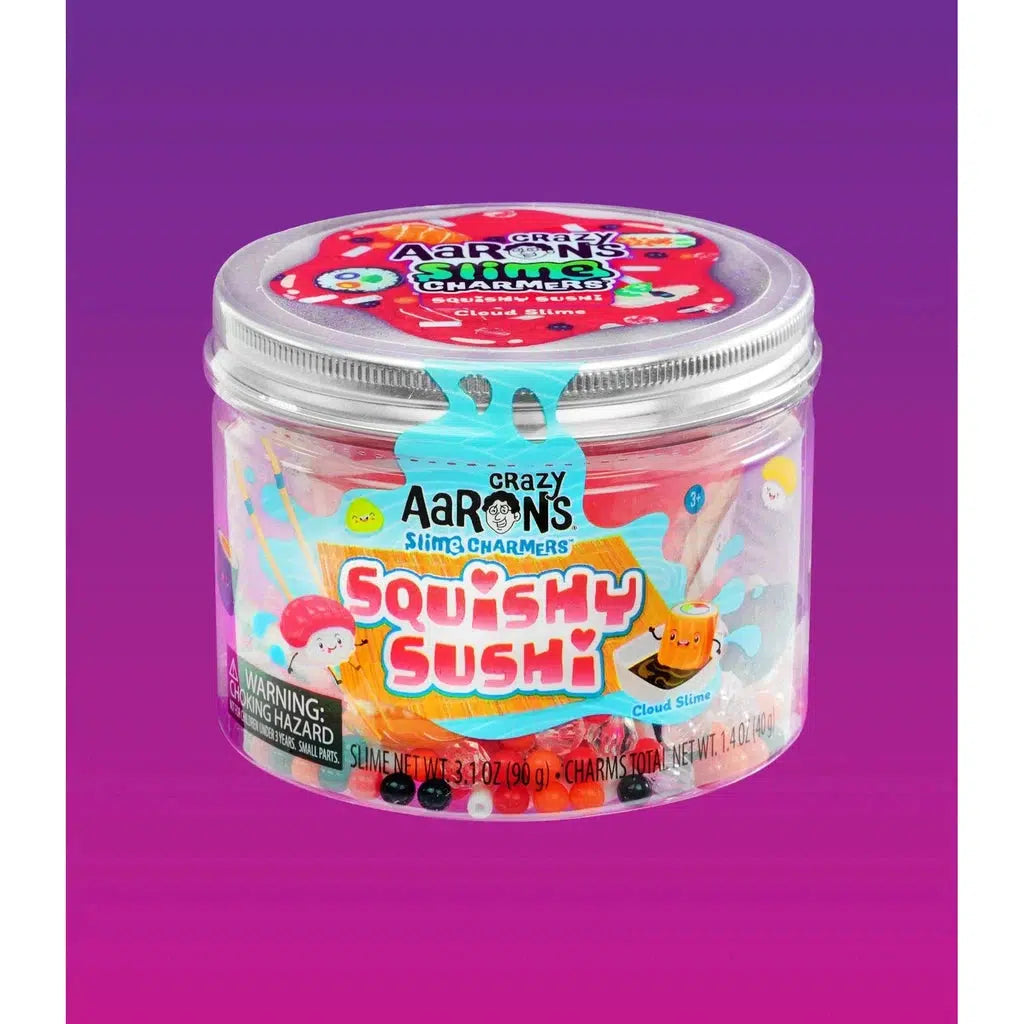 A clear container labeled "Crazy Aaron's Slimy Charmers Squishy Sushi" containing colorful cloud slime and small charms, with a silver lid